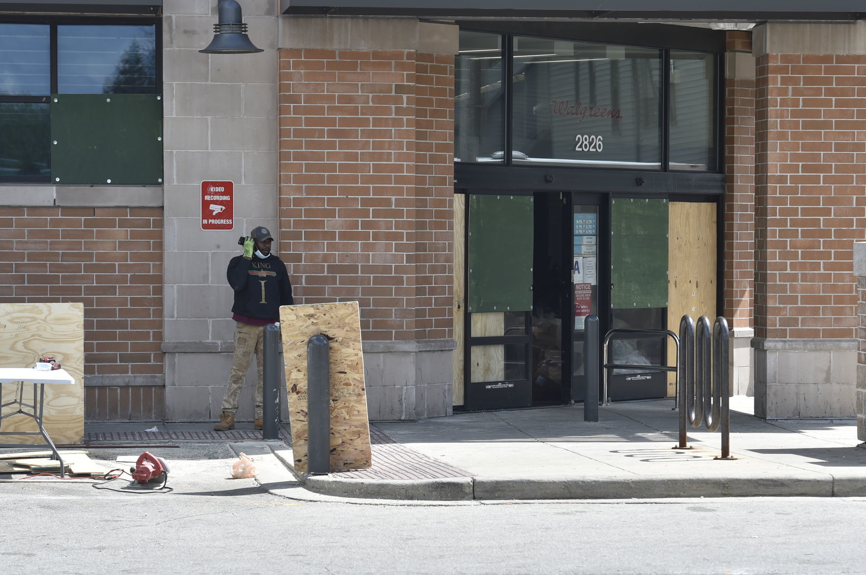 Throughout Saturday, workers endeavored to repair a damaged and partially looted Walgreen's
